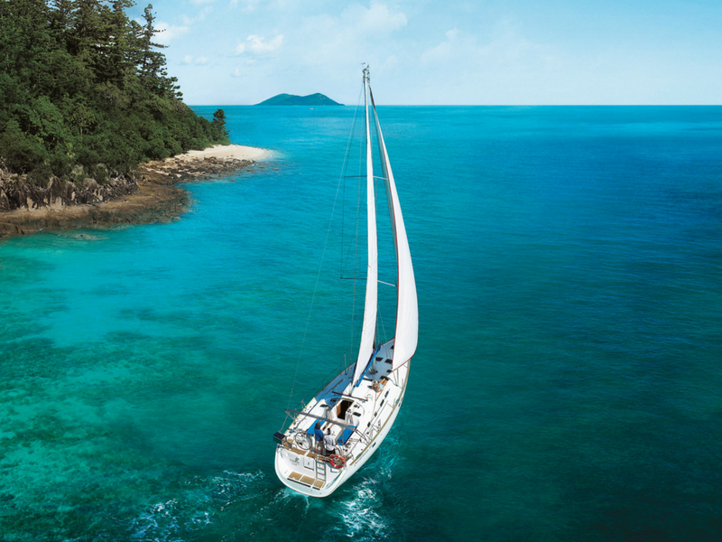 Aerial image of a sailing vessel underway in the Whitsunday Islands