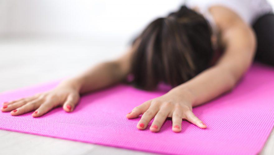 Woman Exercising on Yoga Mat