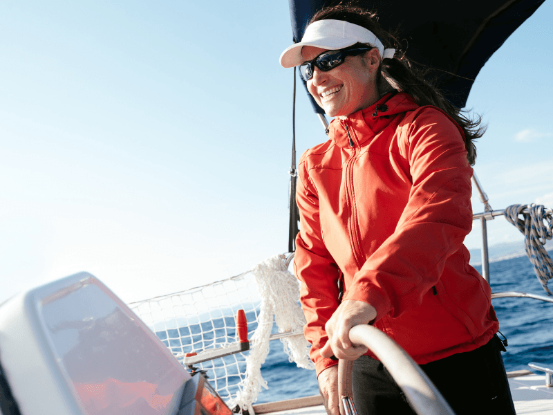 women sailing yacht in red jacket