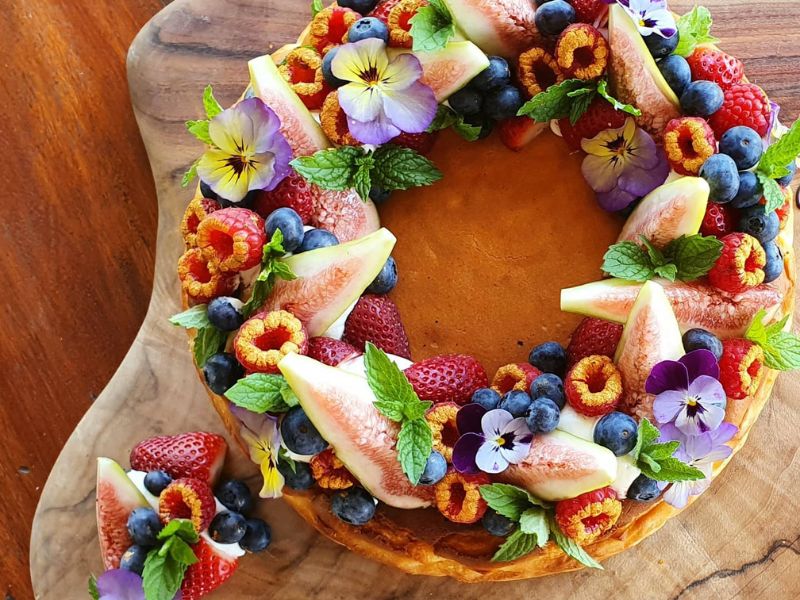 Freshly baked cake with fruit and flowers